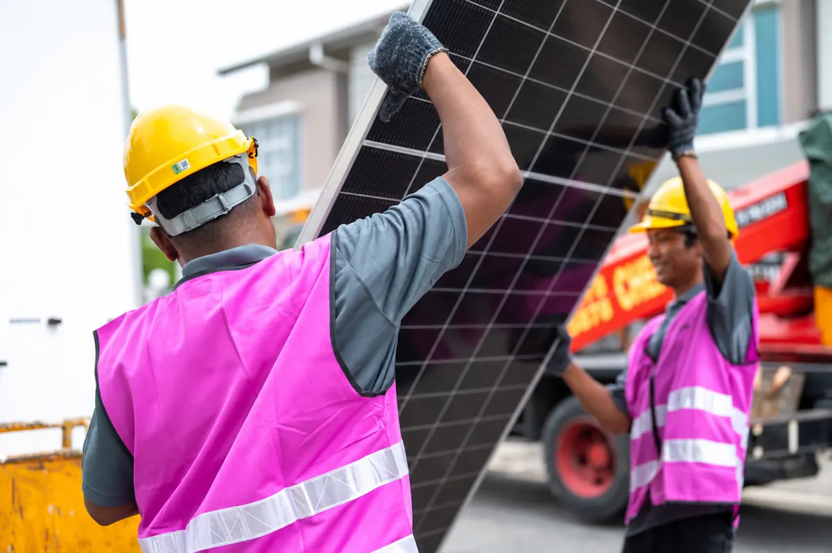 Time Solar installers unloading a panel